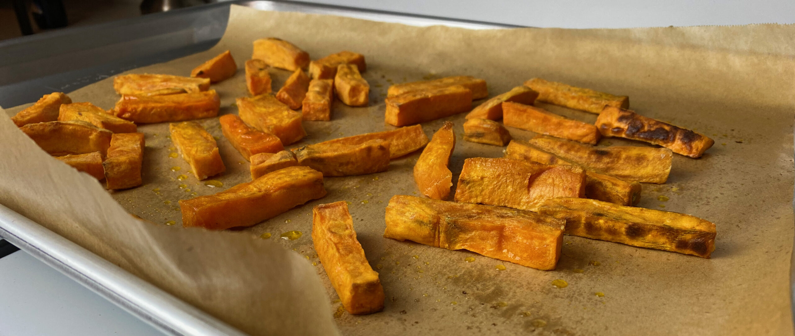 oven baked sweet potato fries on a baking sheet