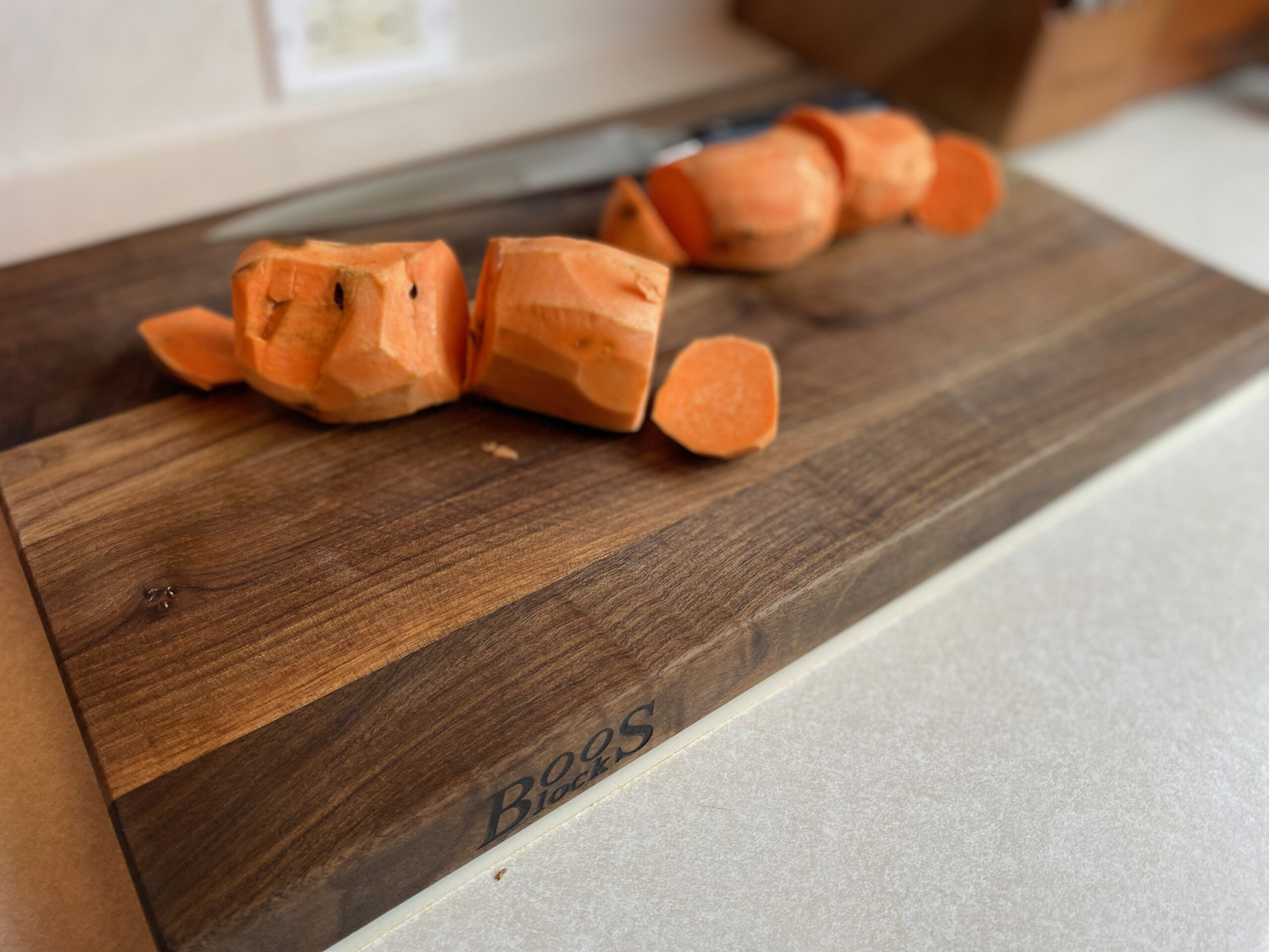 skinned sweet potatoes on a cutting board