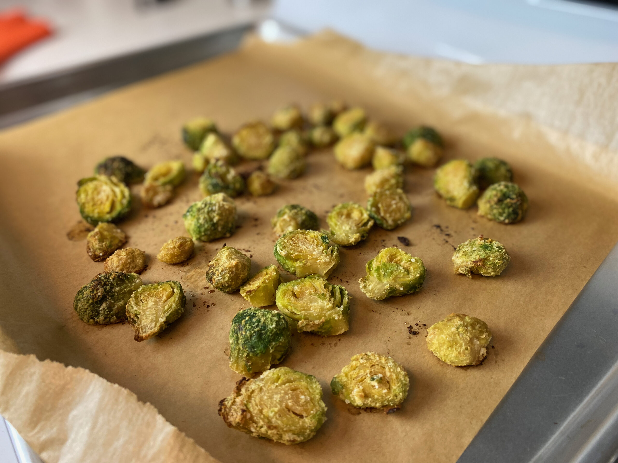 brussels sprouts on a baking sheet and silicone parchment paper