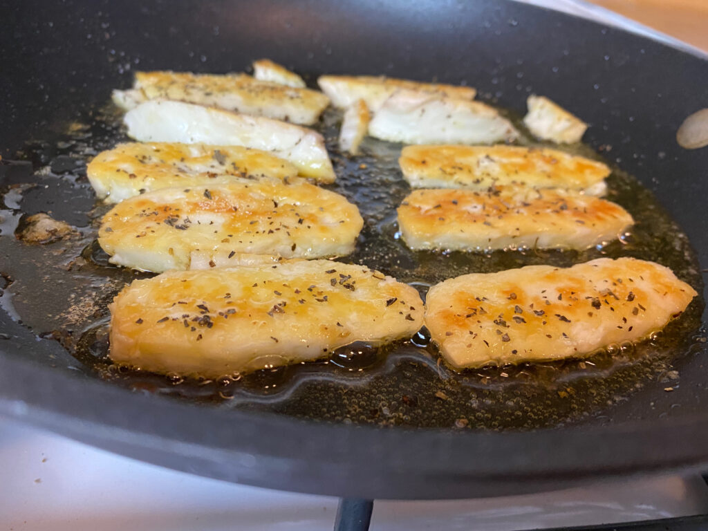 Halloumi after starting to brown and being flipped.