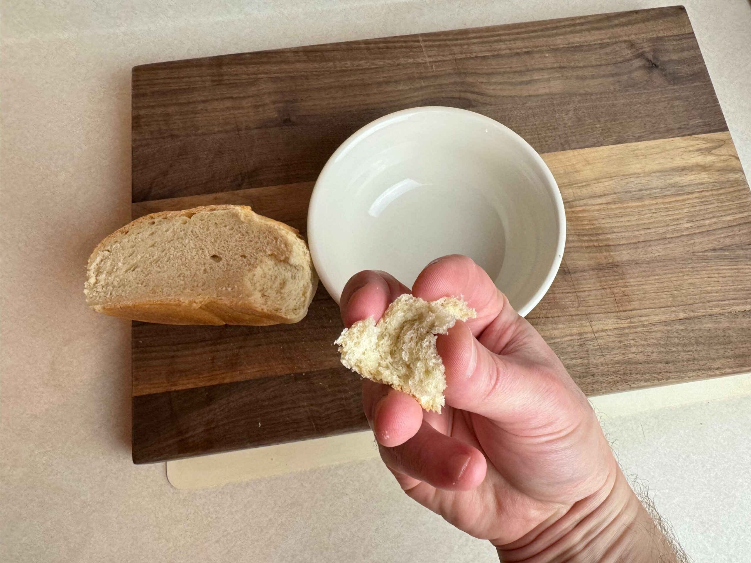 tearing bread to make homemade croutons