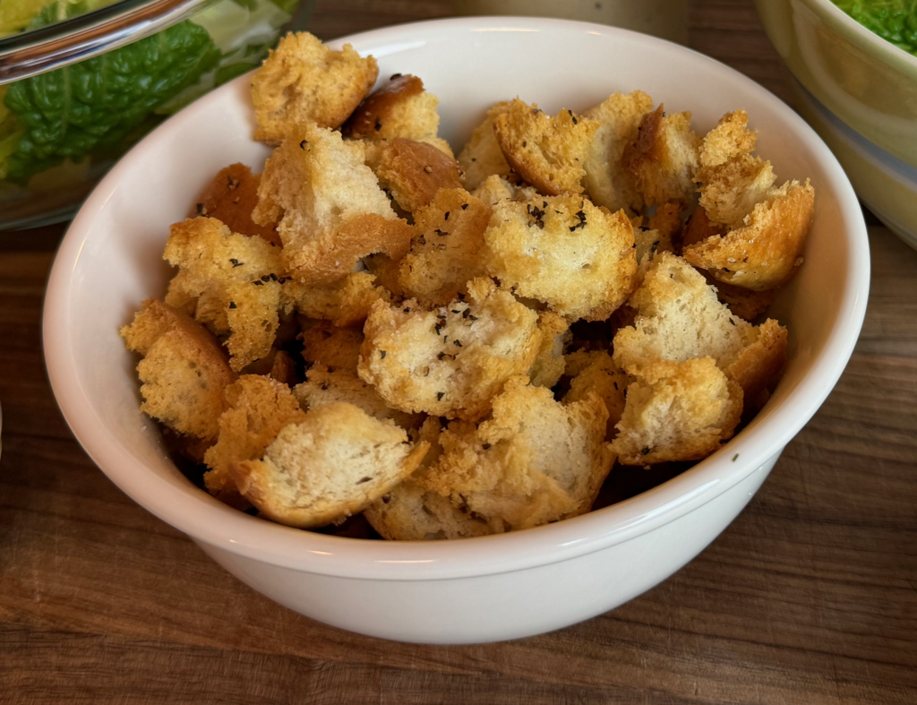 a bowl of homemade croutons for a Caesar salad